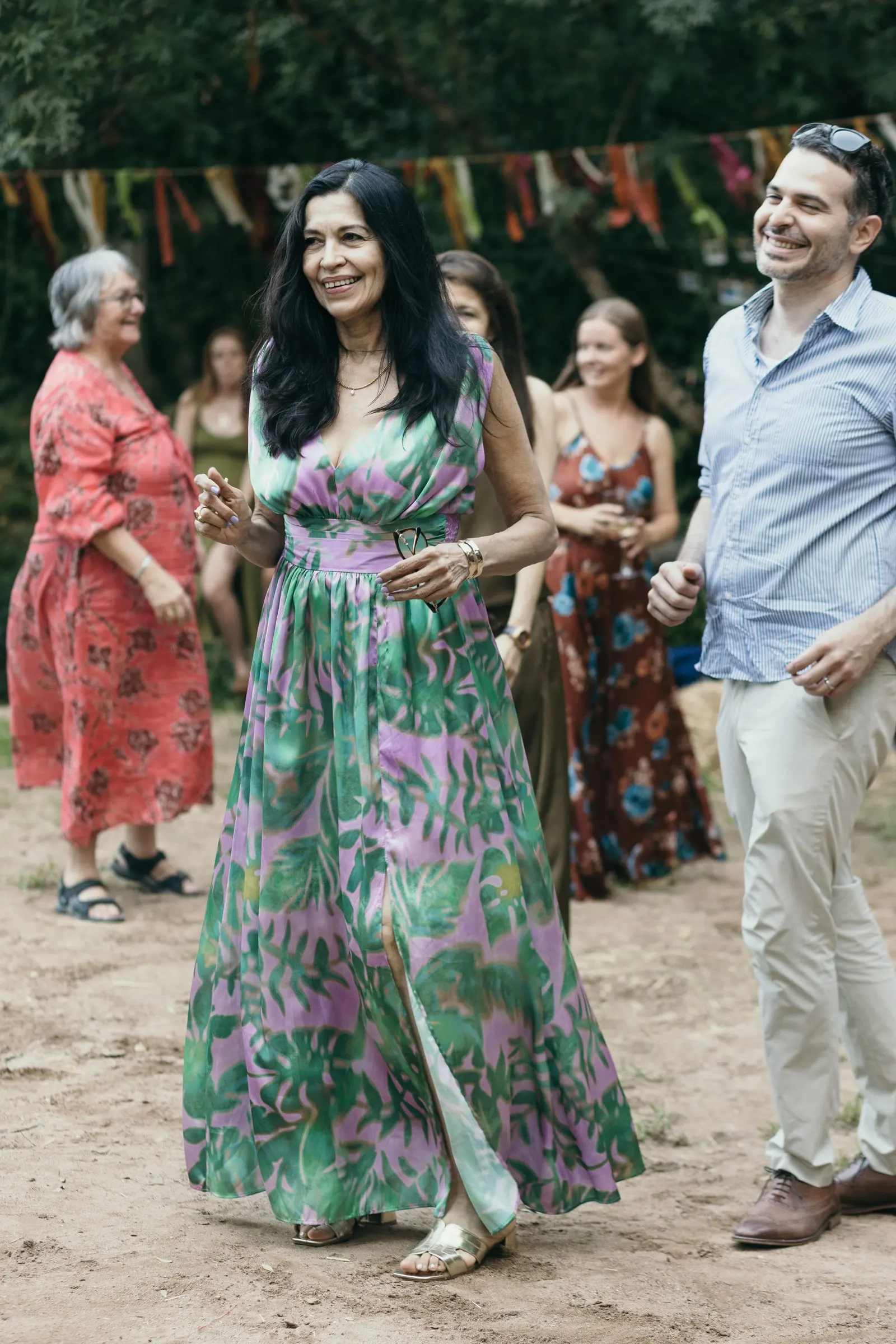 Guest in a floral jumpsuit dancing at the party