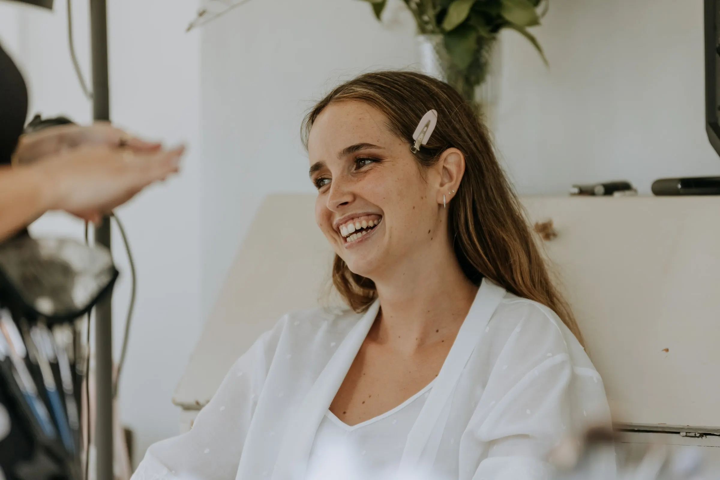 Bride laughing during her make-up on the morning of her wedding in Sotogrande