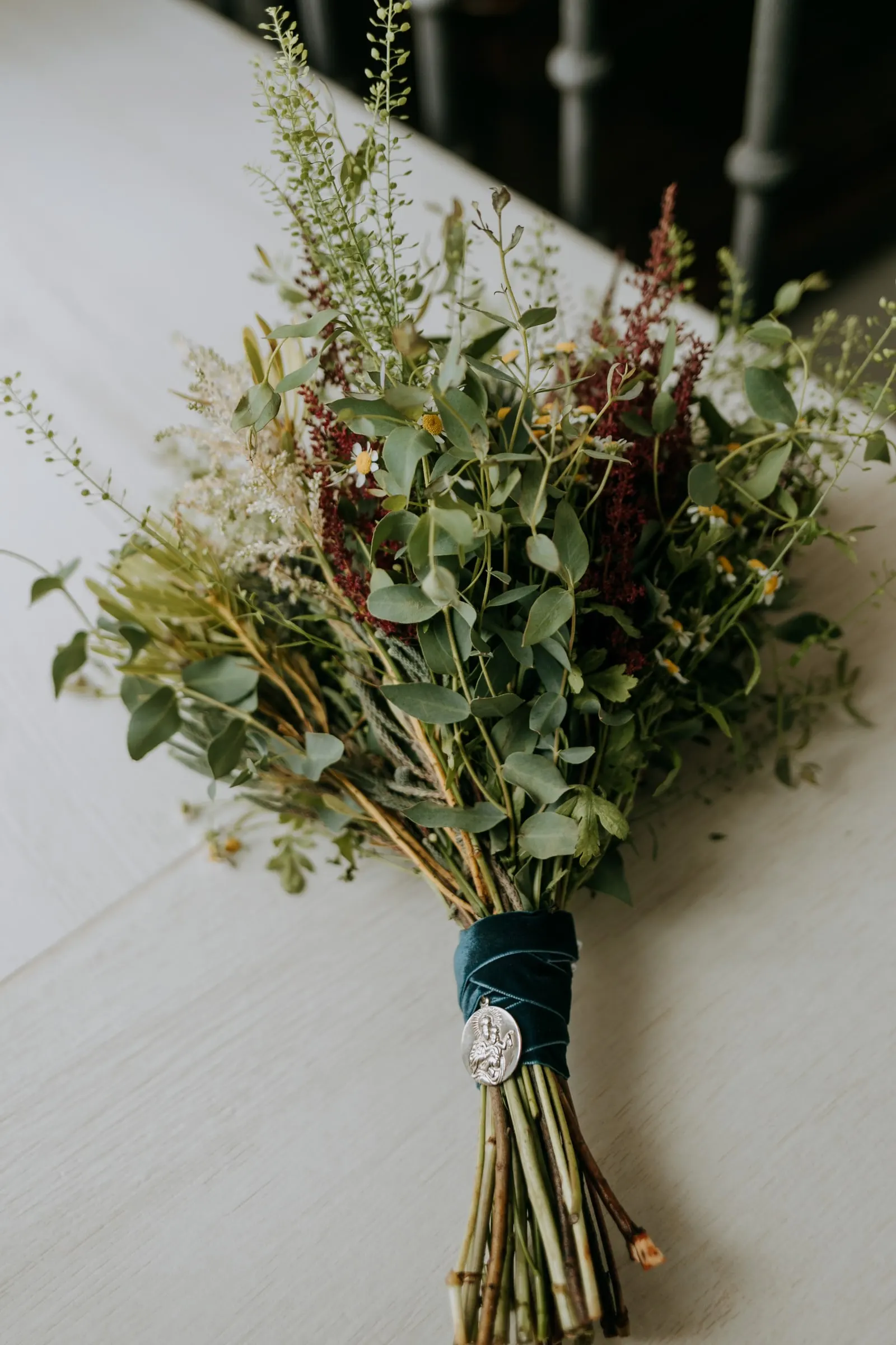 Wild-flower bridal bouquet tied with a velvet ribbon