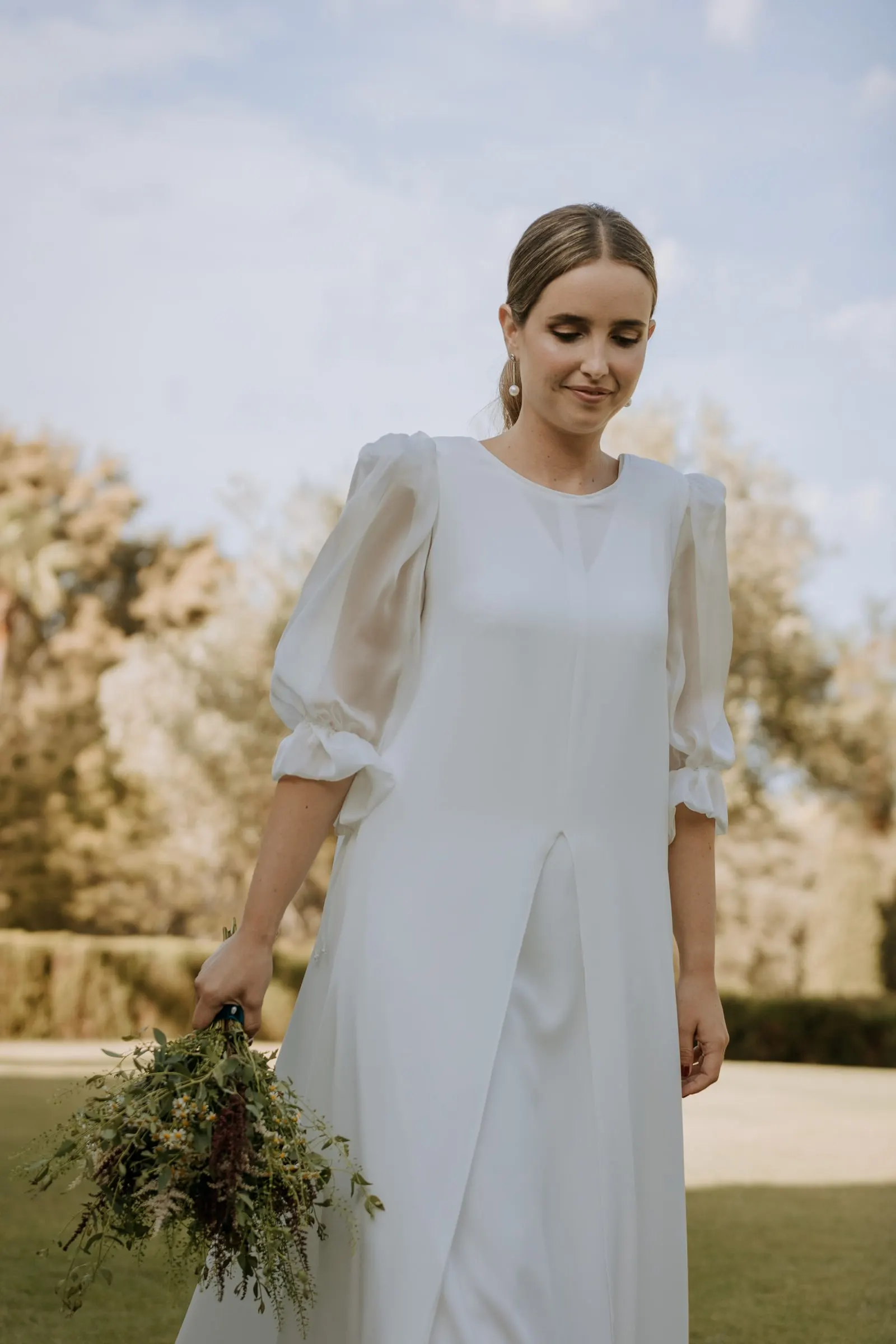 Bride holding her wild-flower bouquet in the afternoon sun, Sotogrande