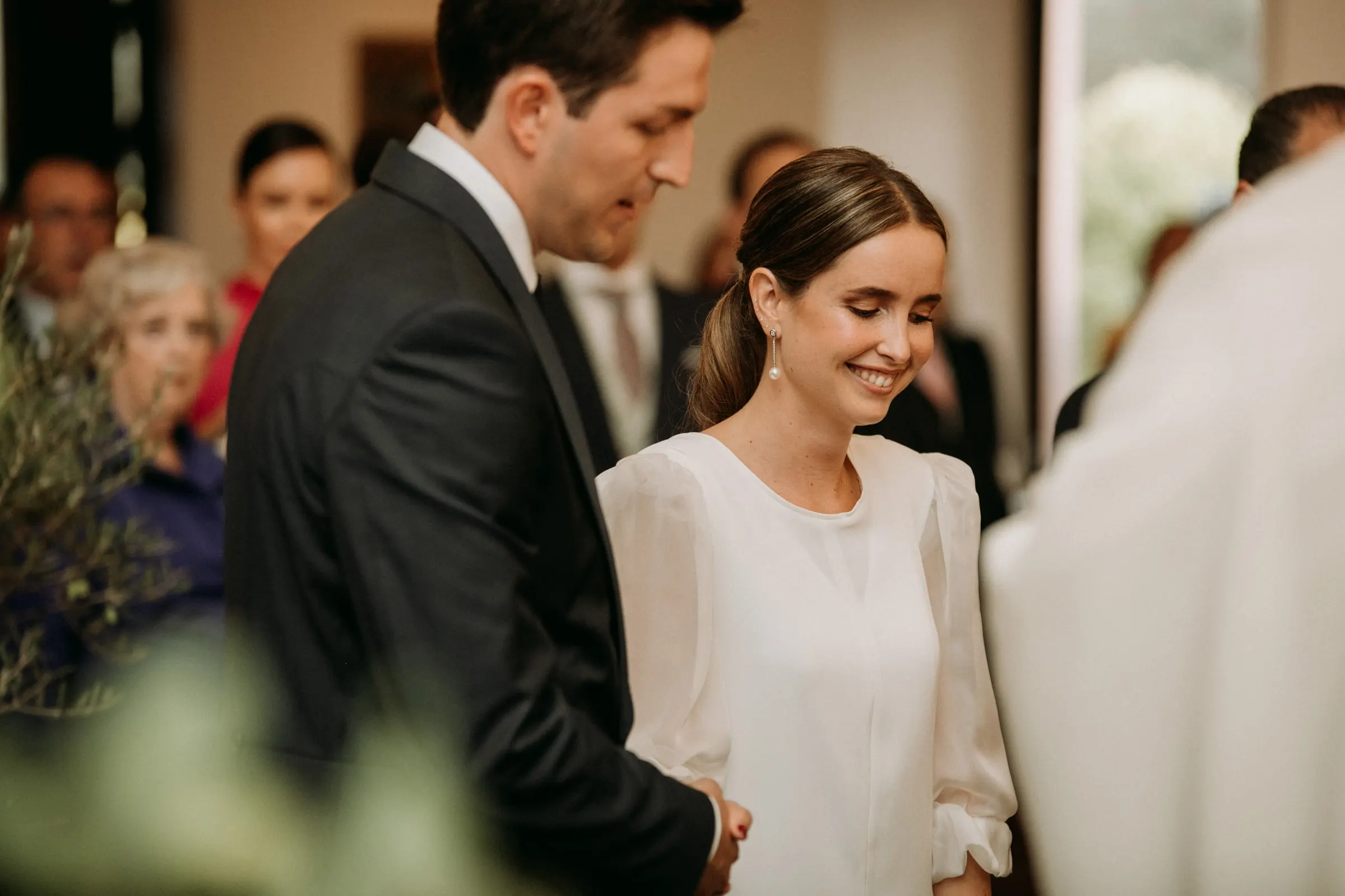 Bride and groom smiling at each other during the vows