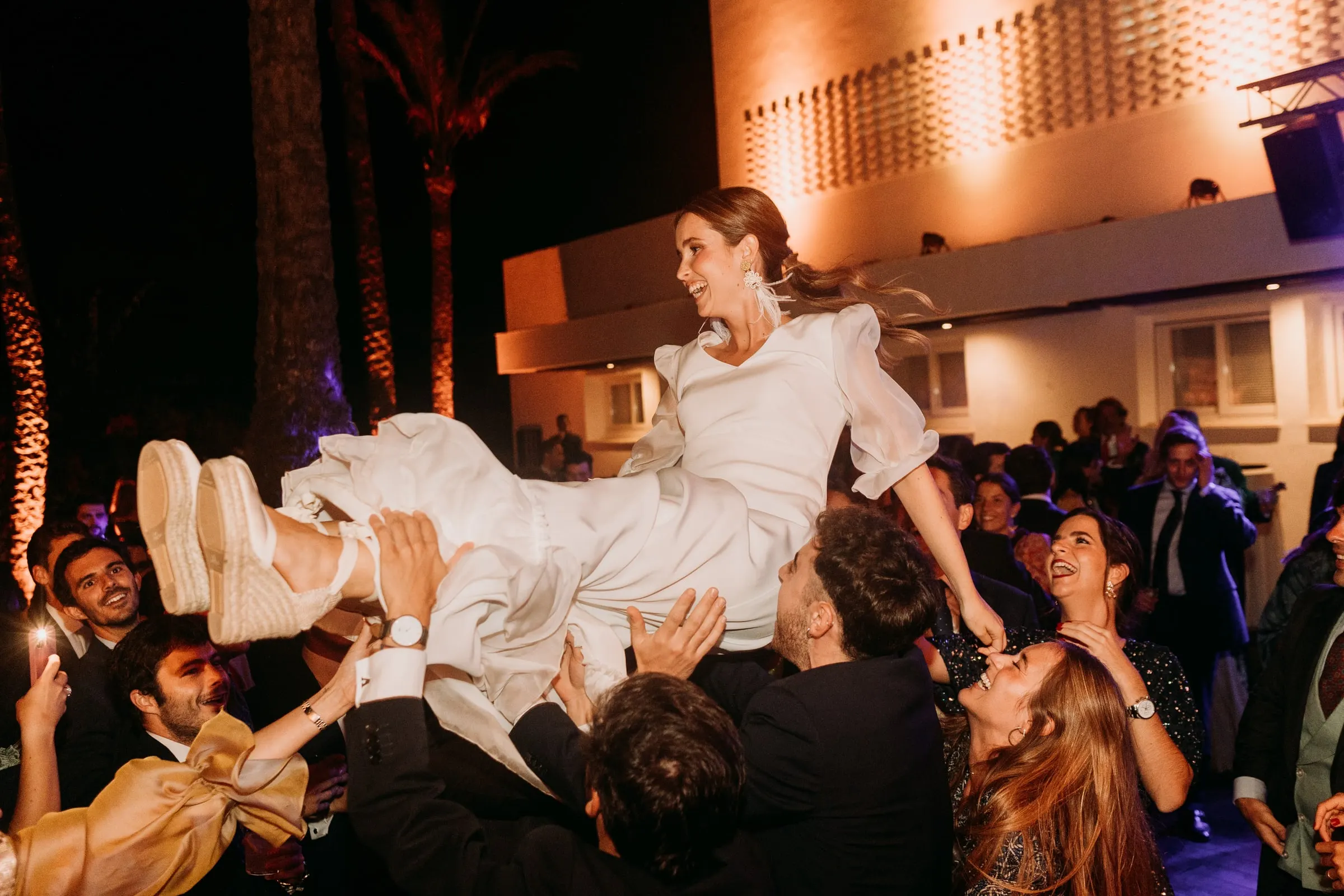 Bride lifted high by the guests on the dance floor in Sotogrande