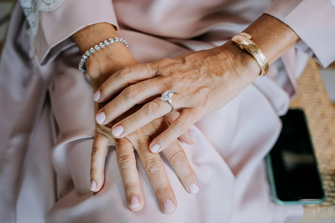 Close-up of the bride's engagement ring and bracelets