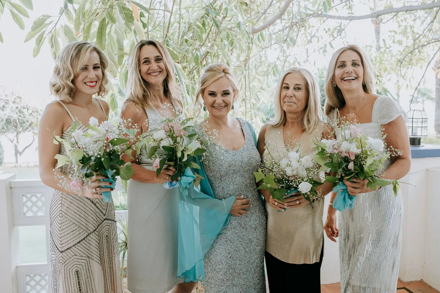Bride with five friends holding bouquets on the balcony, Estepona
