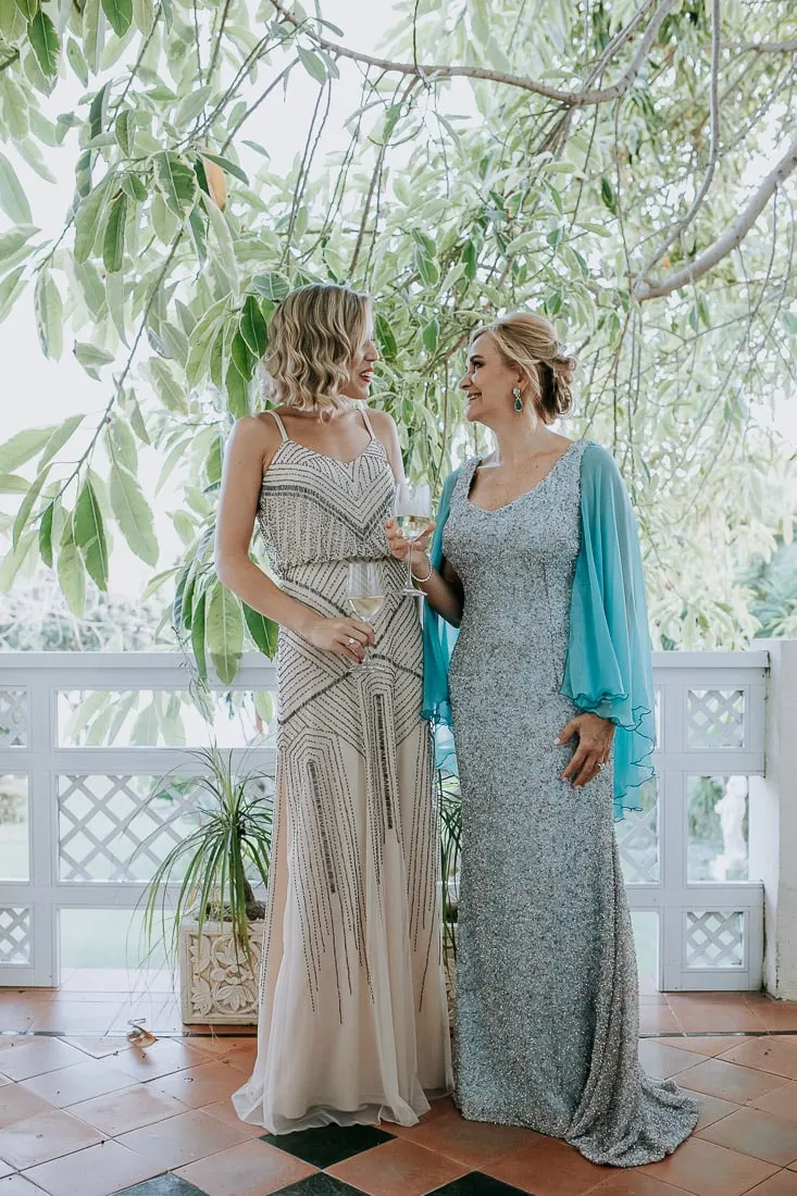 Bride with a friend in a beaded dress on the terrace