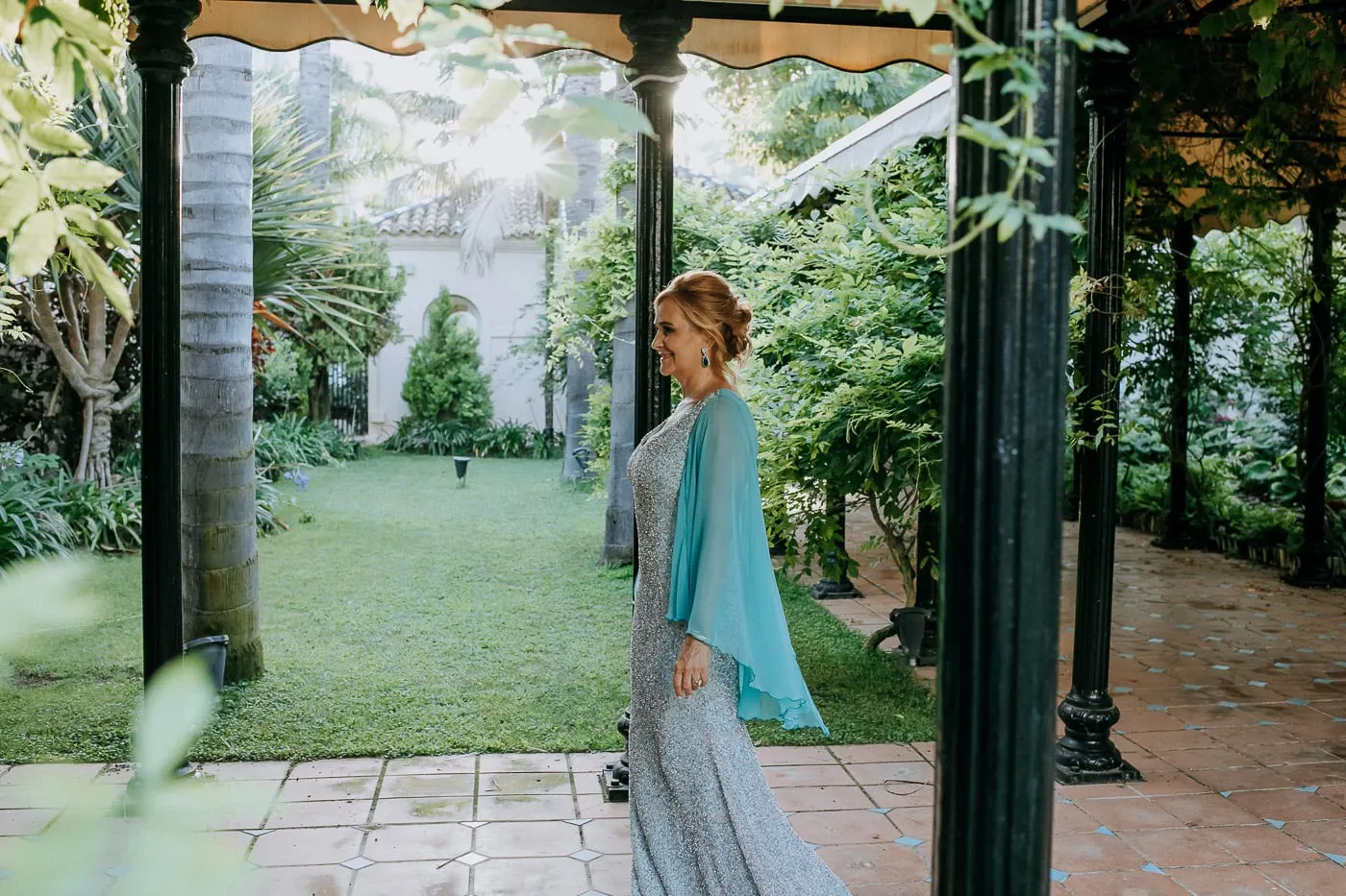 Bride looking out over the garden from the pergola