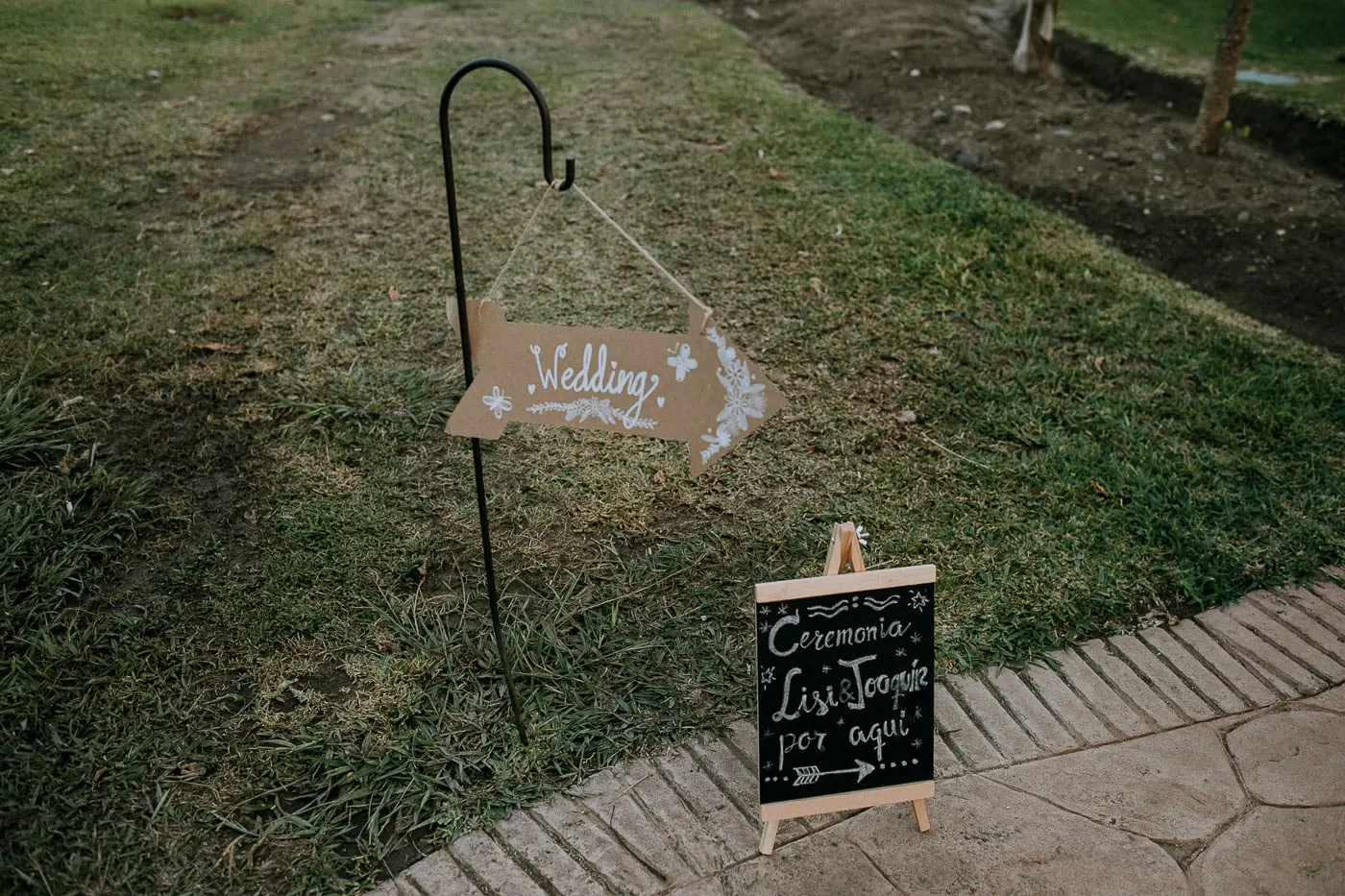 Wedding sign and chalkboard pointing the way to the ceremony on the lawn