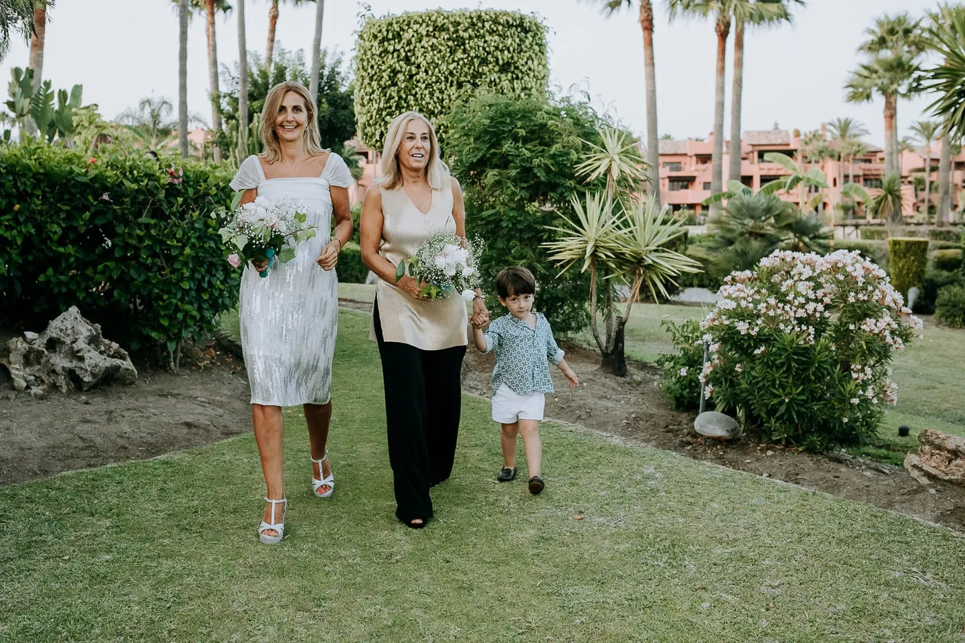 Two friends and a little boy walking to the ceremony