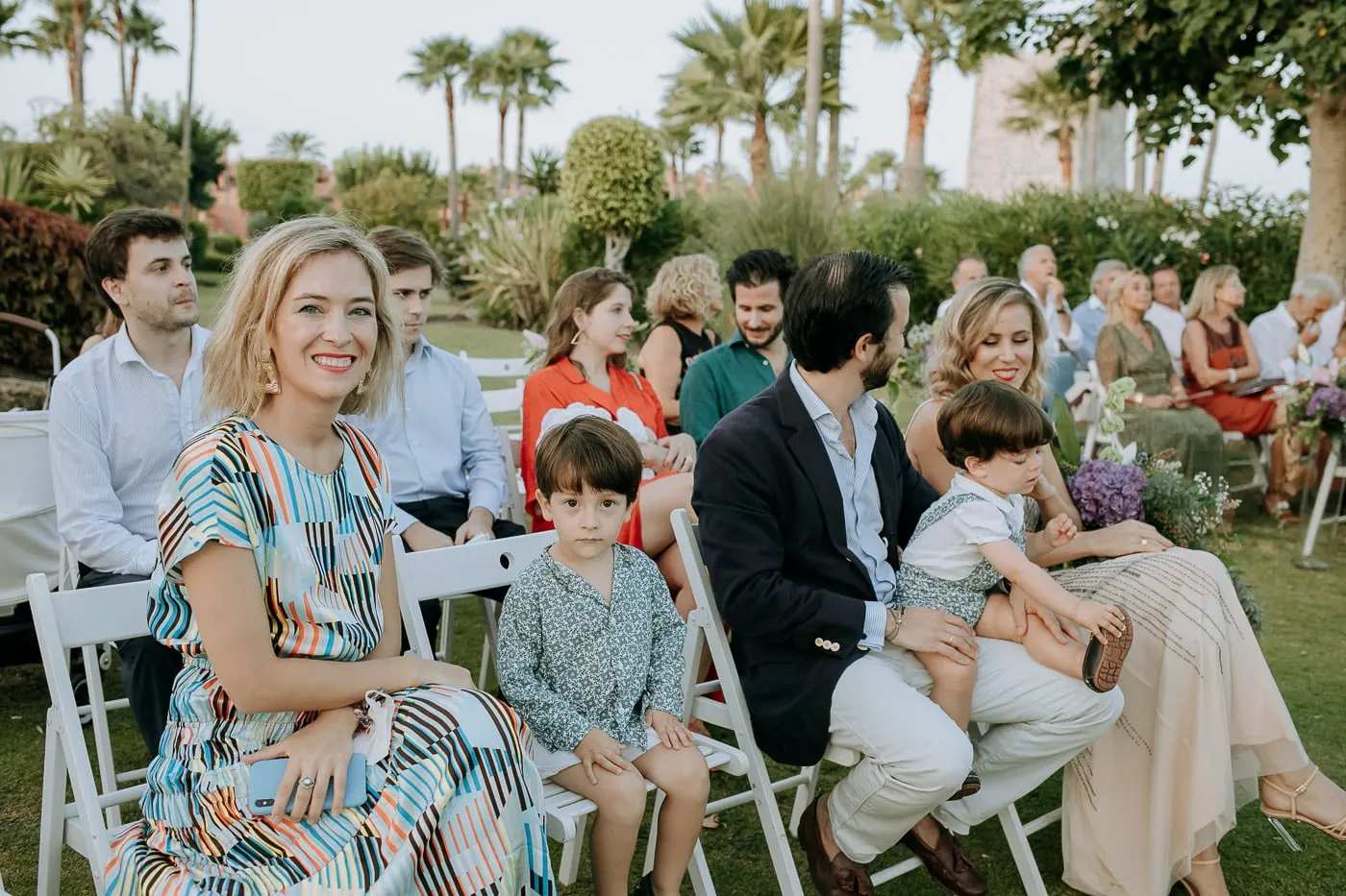 Guests smiling in the rows of white chairs, Estepona