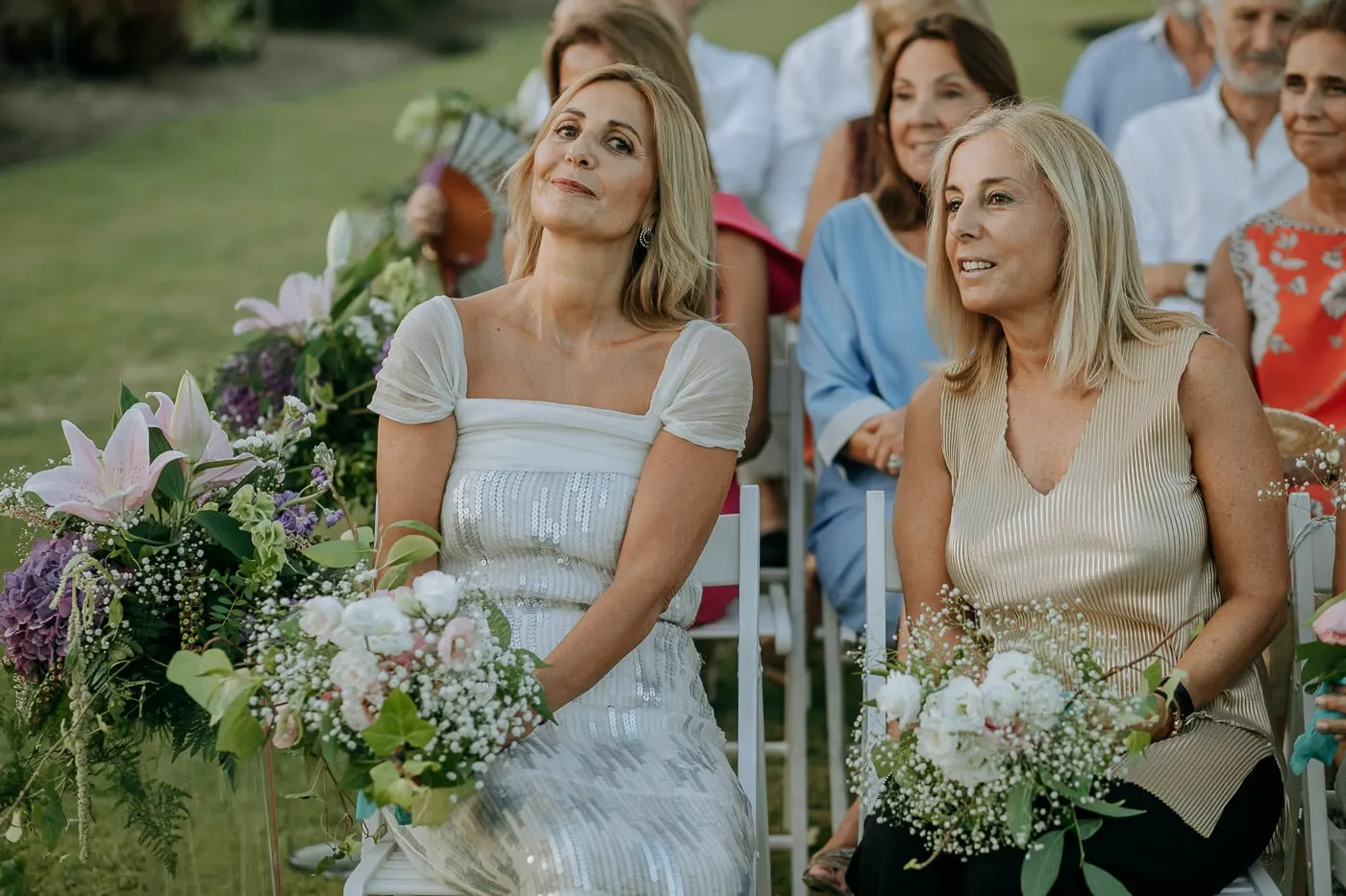 Friends in pale dresses listening to the readings
