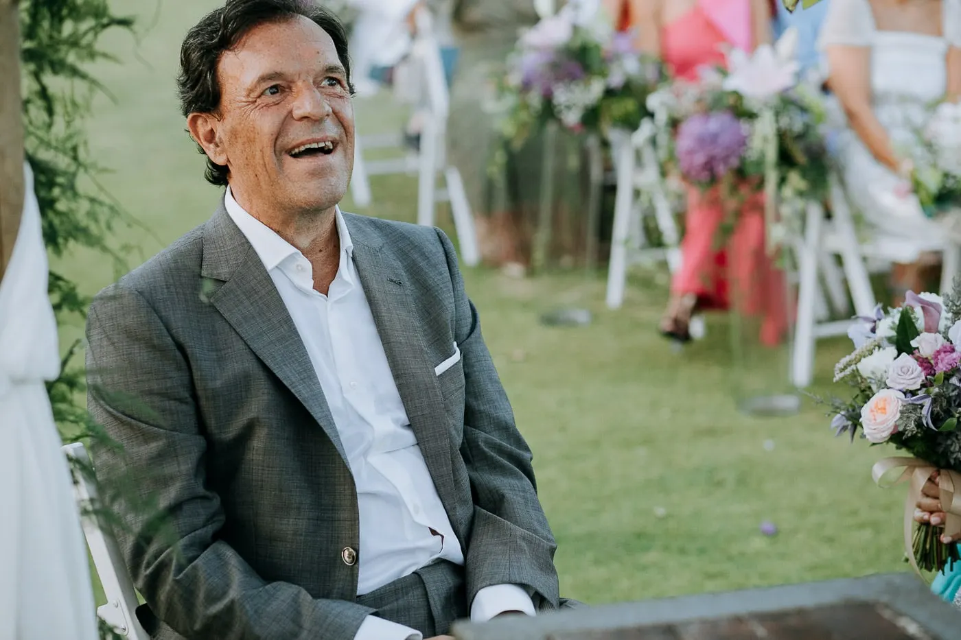 Groom laughing during the ceremony in the garden