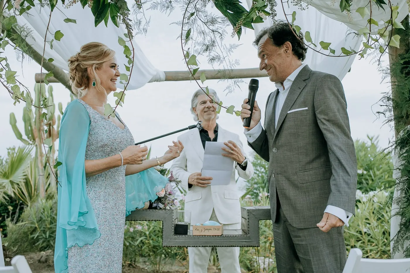 Groom saying his vows into a microphone
