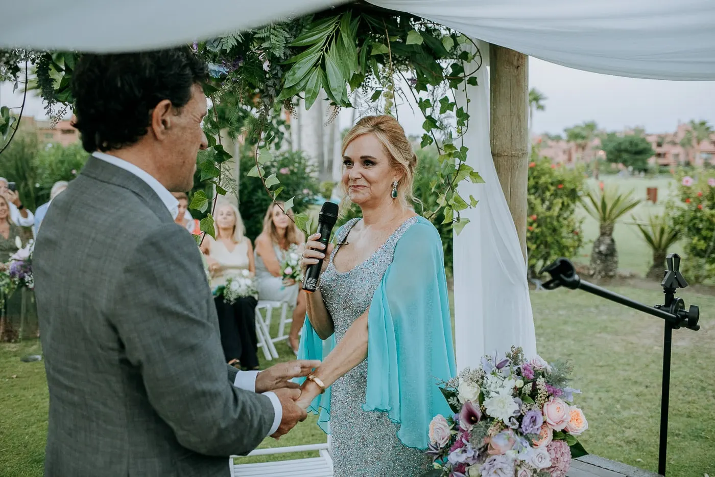 Bride saying her vows holding the groom's hand
