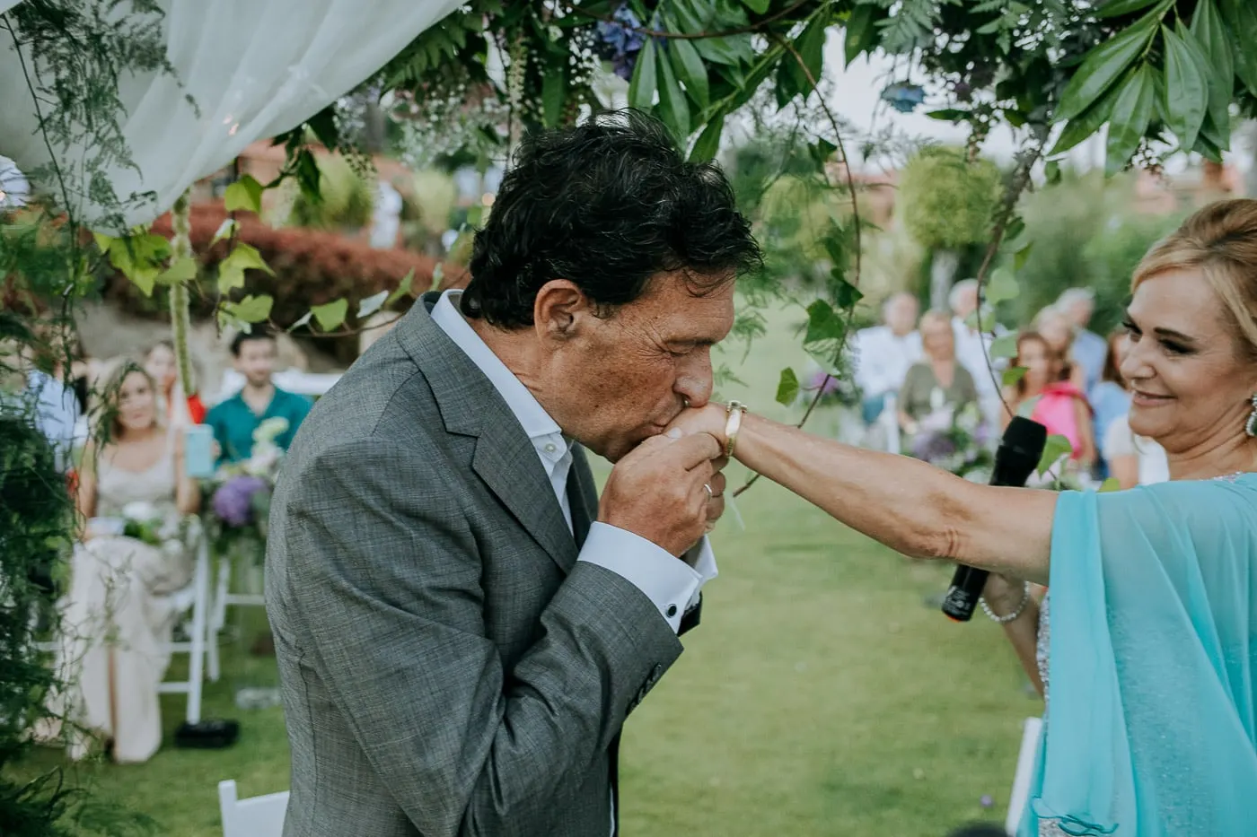 Groom kissing the bride's hand after the rings