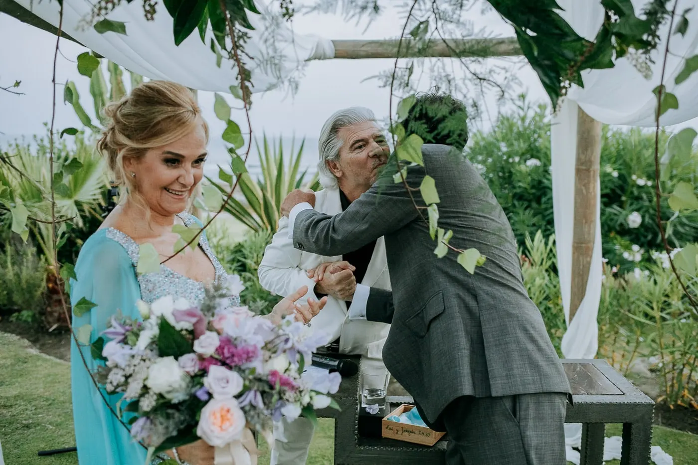 Groom hugging the officiant at the end of the ceremony