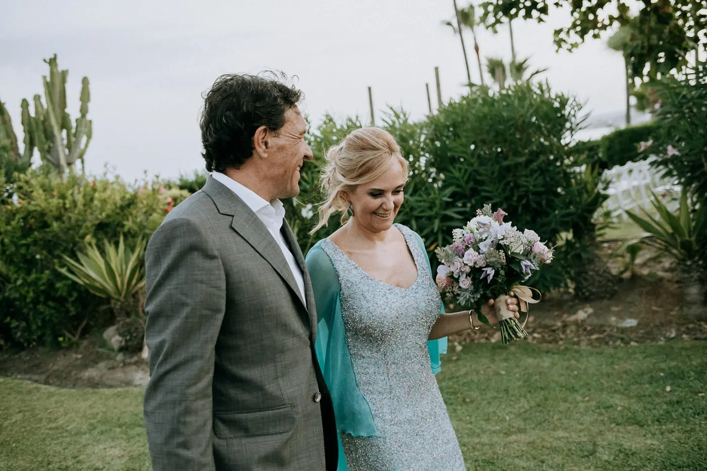 Bride and groom laughing together by the cacti