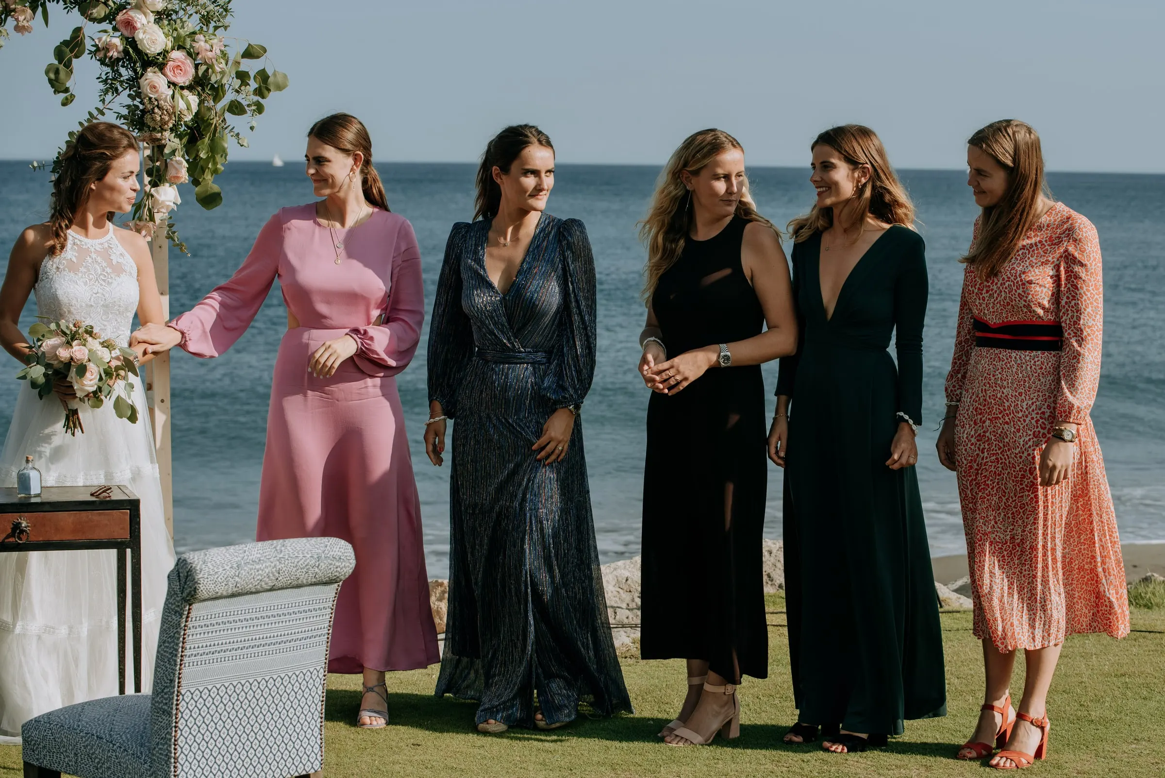 The bride beside her five bridesmaids in long dresses during the ceremony, Trocadero, Sotogrande