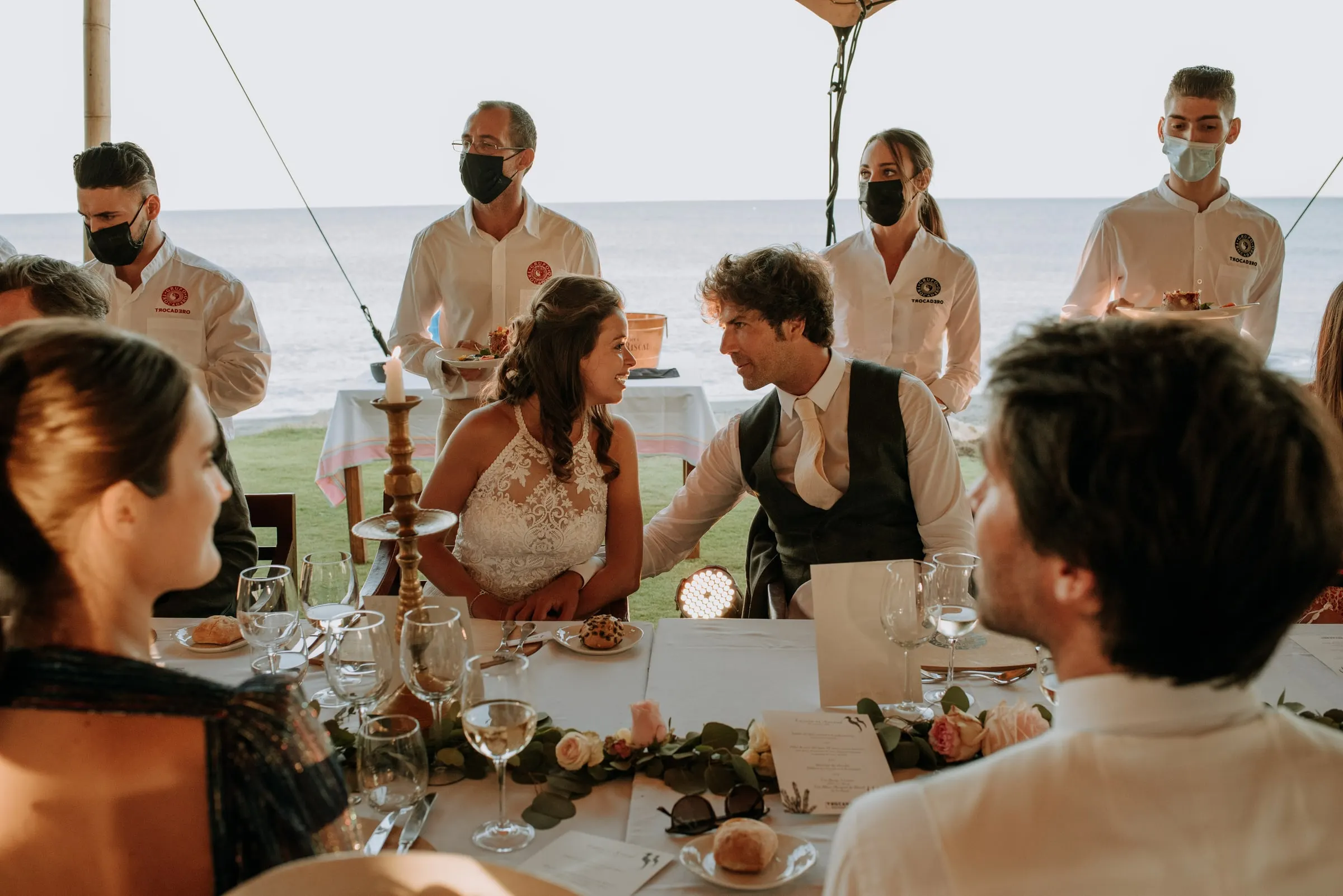 The couple chatting with guests at the dinner table as waiters serve, Trocadero, Sotogrande