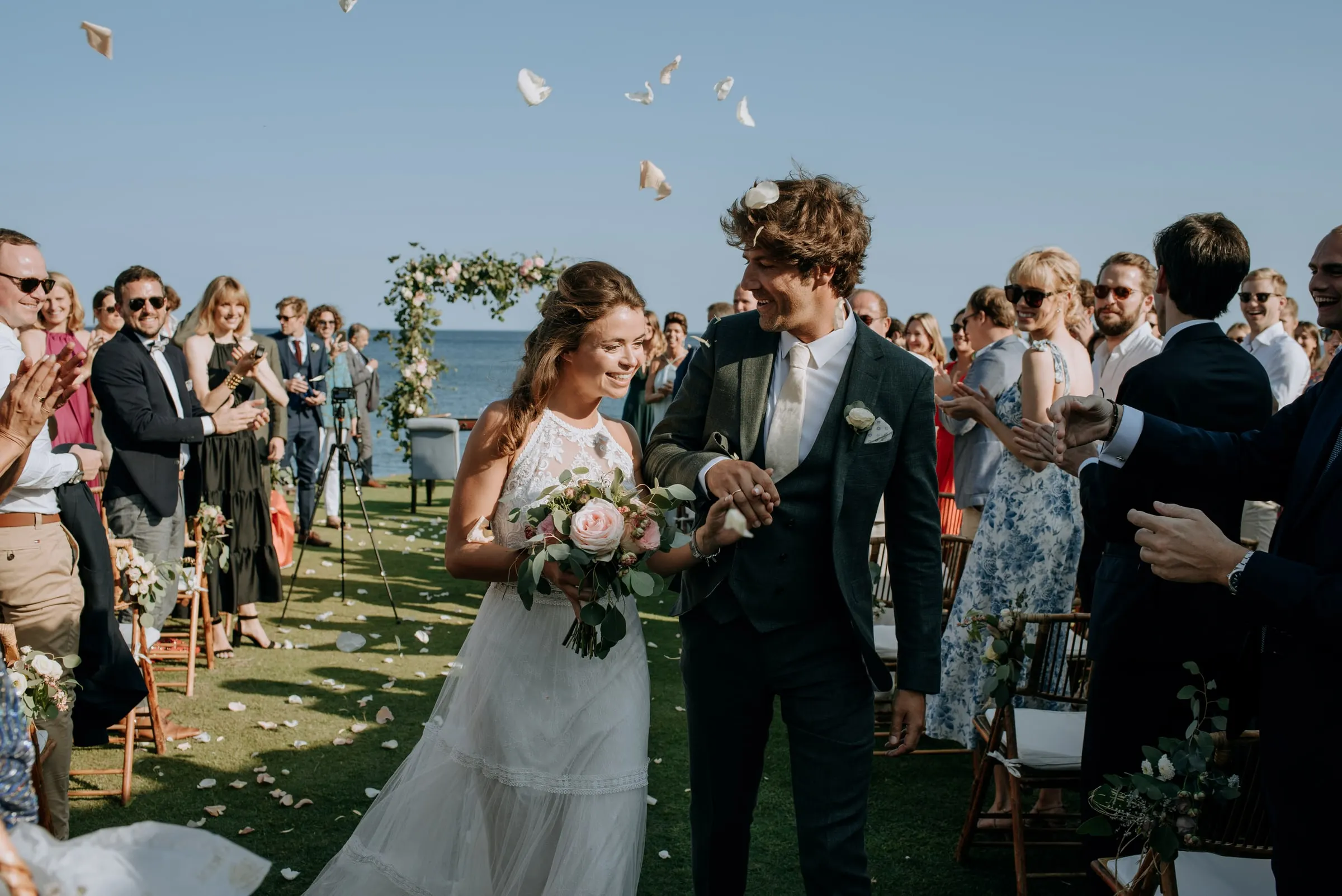 The newlyweds walking up the aisle as guests throw petals over them, Trocadero, Sotogrande