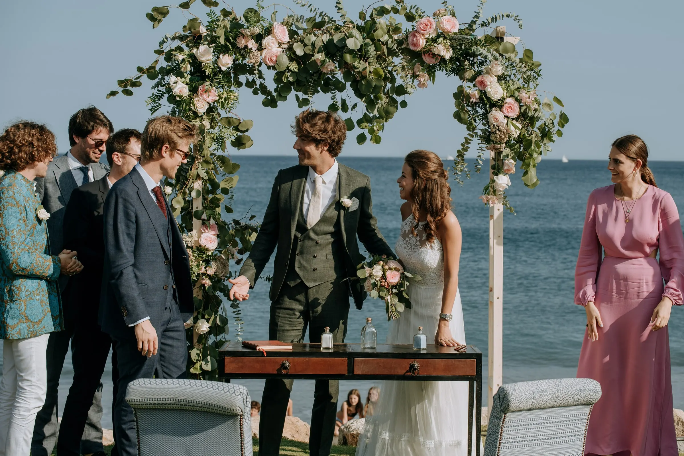 Witnesses gathering round the couple at the ceremony table to sign, Trocadero, Sotogrande