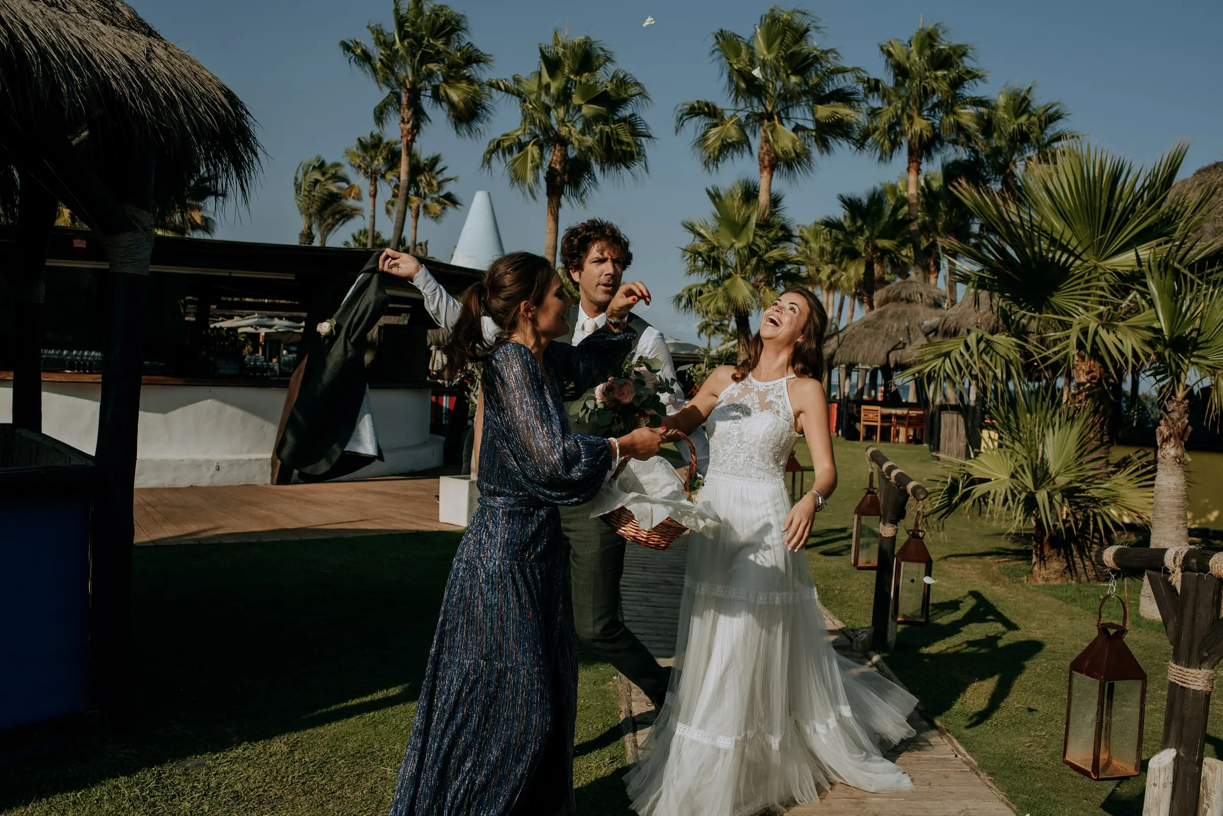The bride dancing with a guest on the lawn among the palm trees, Trocadero, Sotogrande