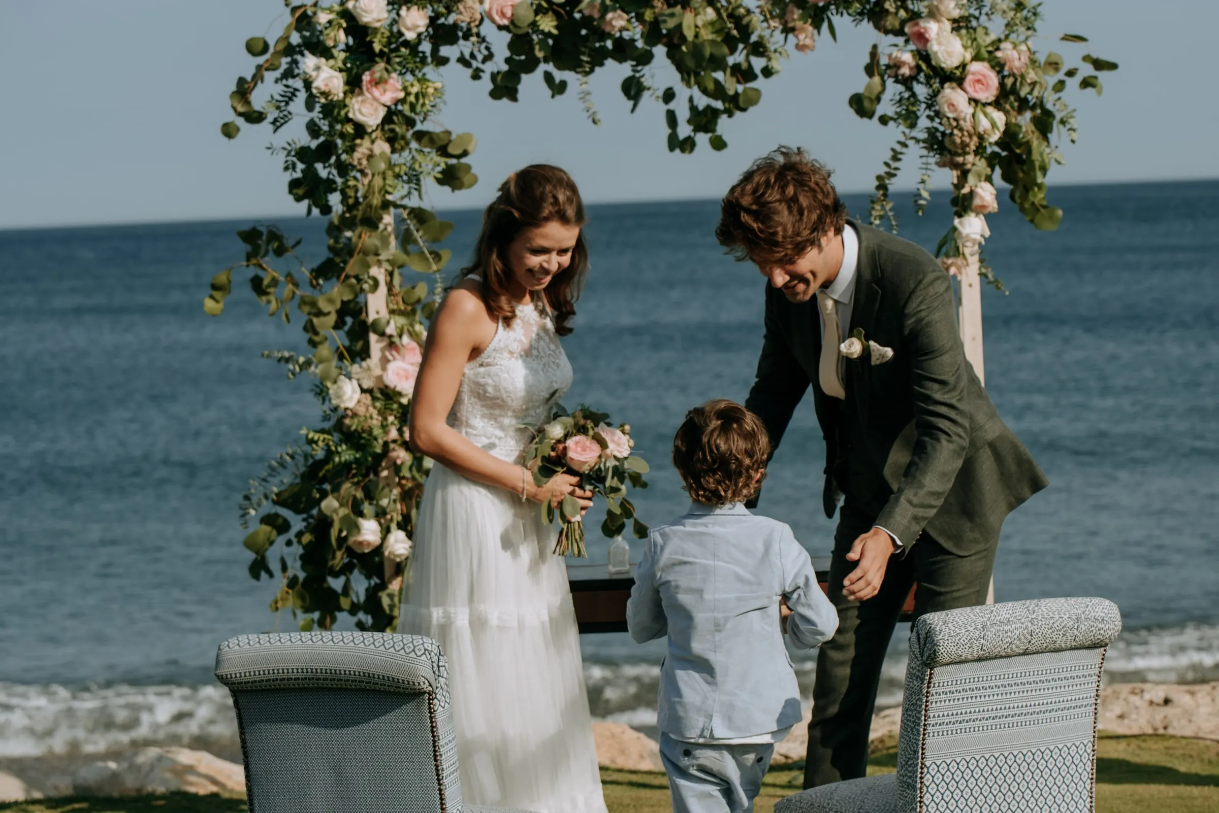 A little boy bringing the rings to the couple under the flower arch, Trocadero, Sotogrande